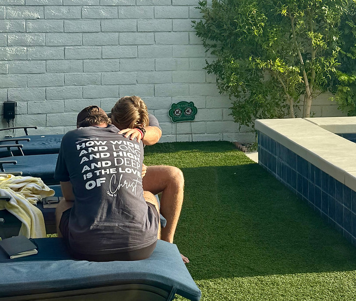 Two students embracing after a baptism