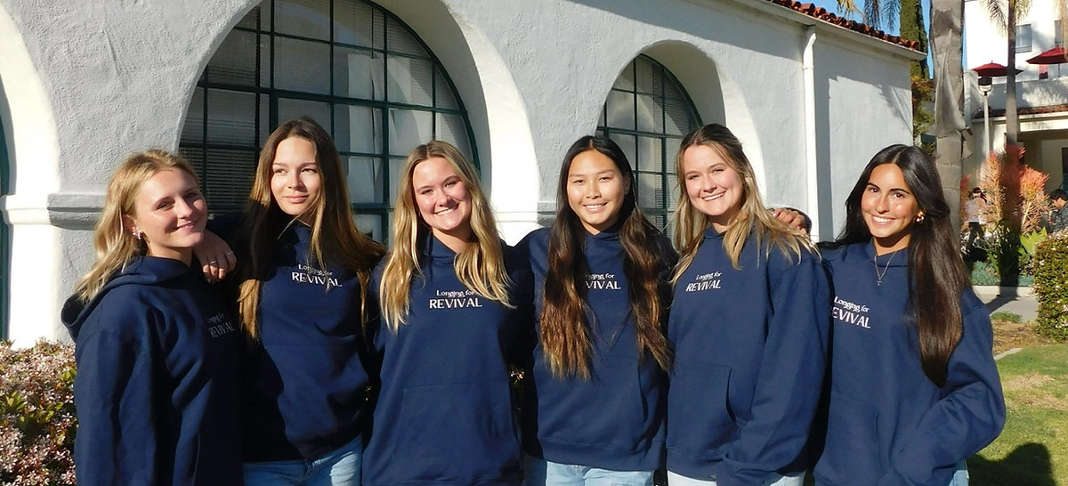 Students in matching sweatshirts standing together outside